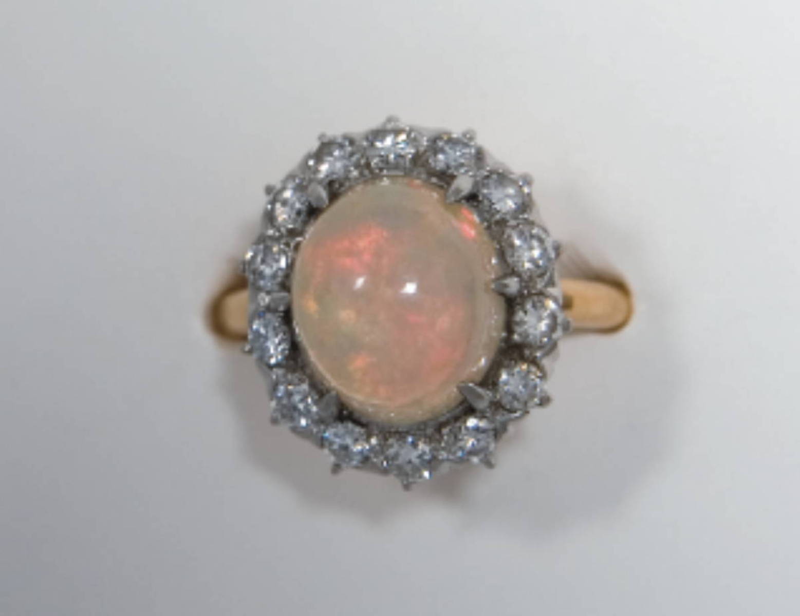 Appraisal: OPAL AND GOLD RING the opal is surrounded by diamonds