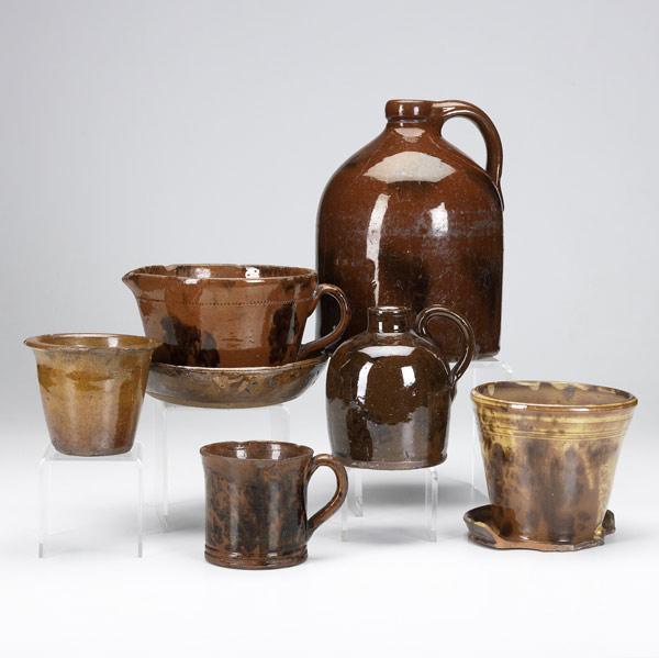 Appraisal: Seven pieces of redware pottery th C Splotch-decorated jug and