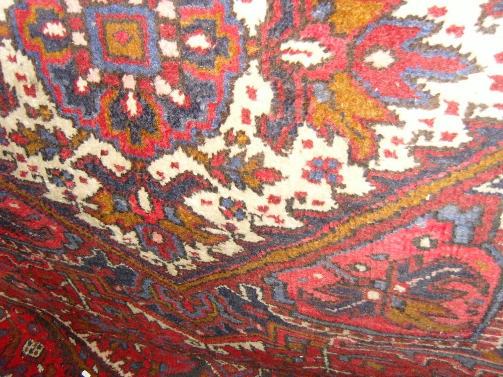 Appraisal: A large red ground eastern wool carpet with geometric decoration