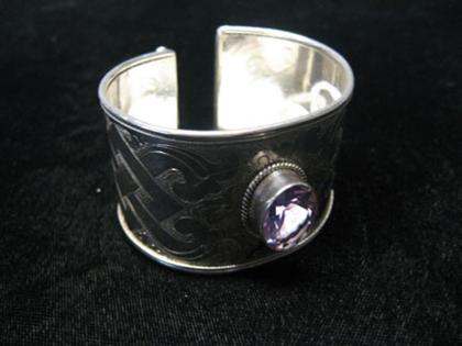 Appraisal: Sterling and amethyst cuff Patterned sterling cuff bracelet with oval