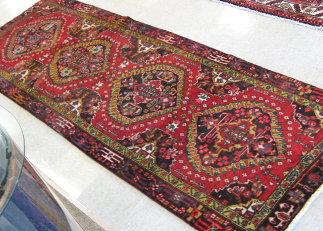 Appraisal: PERSIAN HALL CARPET Azarbaijan region northwestern Iran featuring four flower-filled