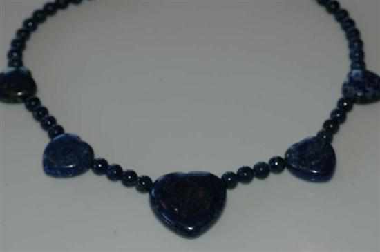 Appraisal: A LAPIS LAZULI BEAD NECKLACE WITH HEART SHAPED SPACERS