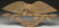 Appraisal: ANTIQUE CARVED SPREAD-WINGED EAGLE ON ARROW W BANNER With carved