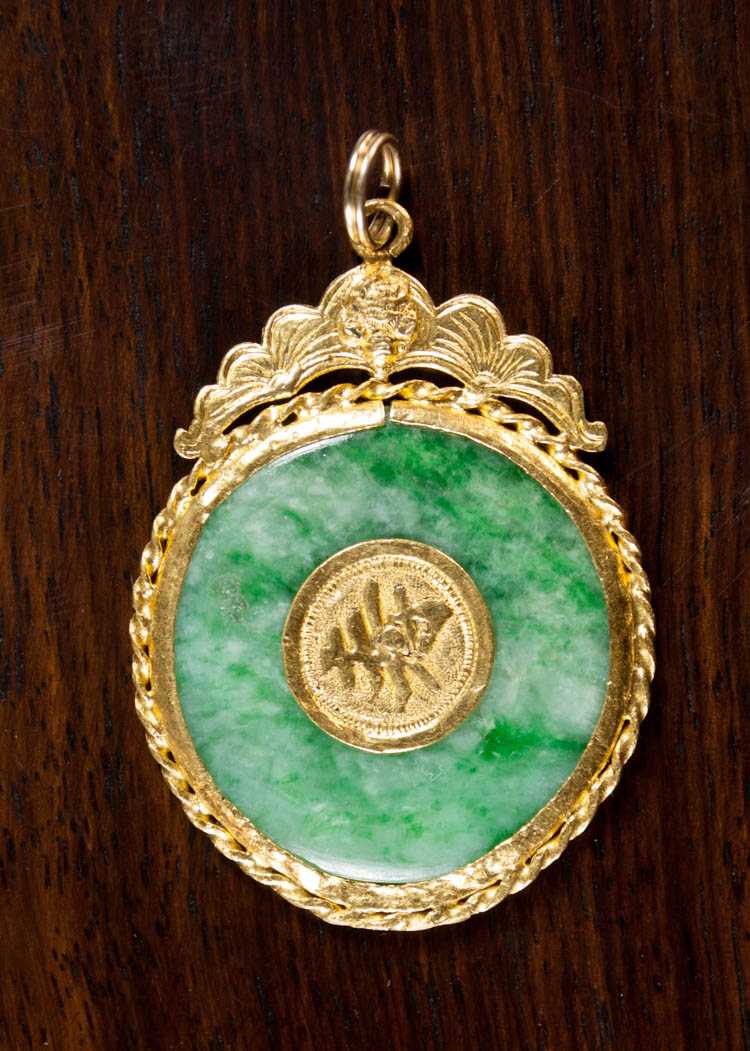 Appraisal: CHINESE JADE AND TWENTY-FOUR KARAT GOLD PENDANT with a rotating