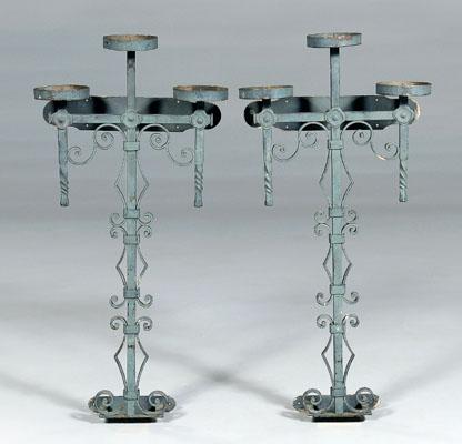 Appraisal: Pair iron sconces each with three platforms above scrolled and