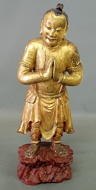 Appraisal: Asian carved wood deity figure with gilt decoration probably early