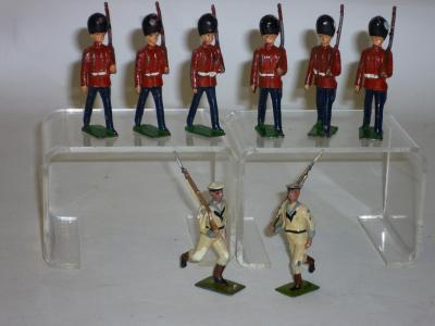 Appraisal: Eight metal soldiers comprising six British made guards marching with