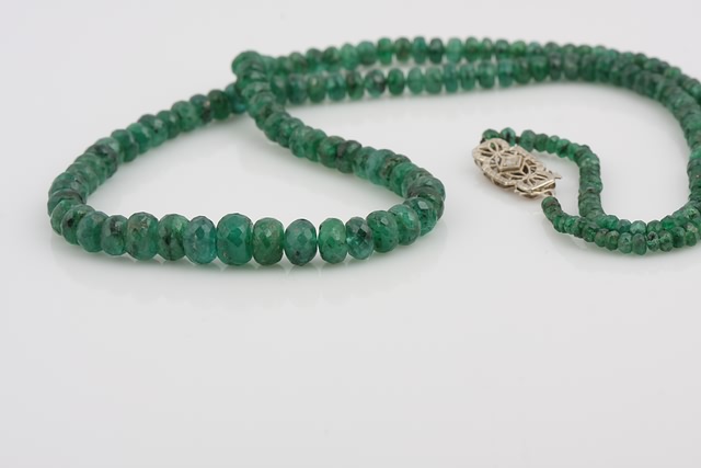 Appraisal: long strand of - mm diameter graduated round faceted emerald