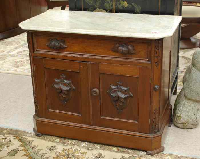 Appraisal: VICTORIAN WALNUT WASHSTAND American c having a rectangular white marble