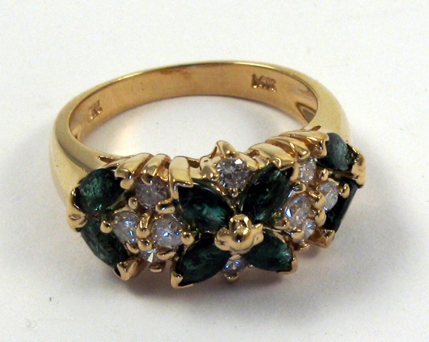 Appraisal: EMERALD AND FOURTEEN KARAT GOLD RING set with eight marquise-cut