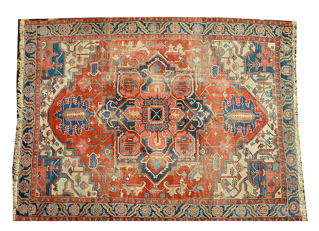 Appraisal: A HERIZ RED GROUND SMALL CARPET with stylised design to