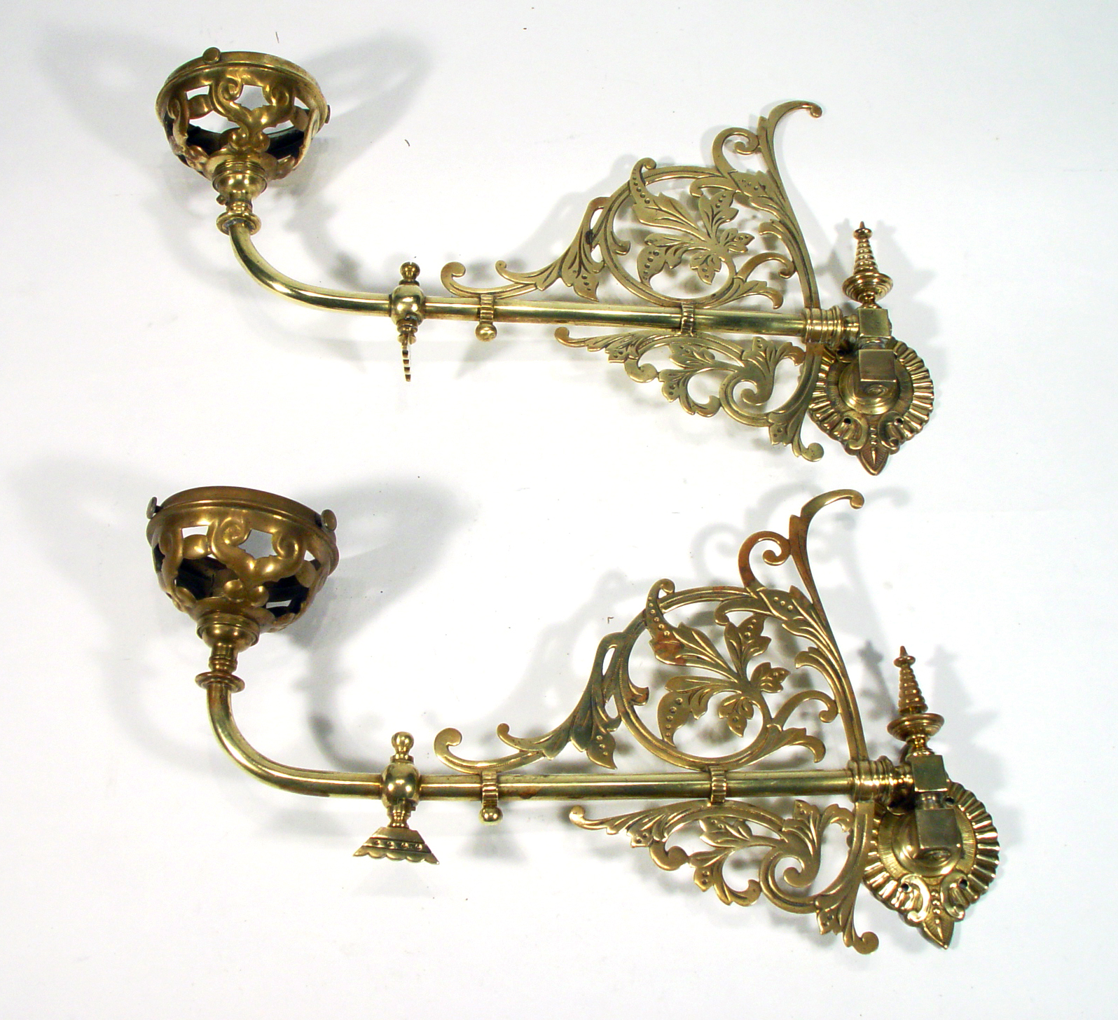 Appraisal: Pair of Victorian hinged brass wall sconces pierced with stylised