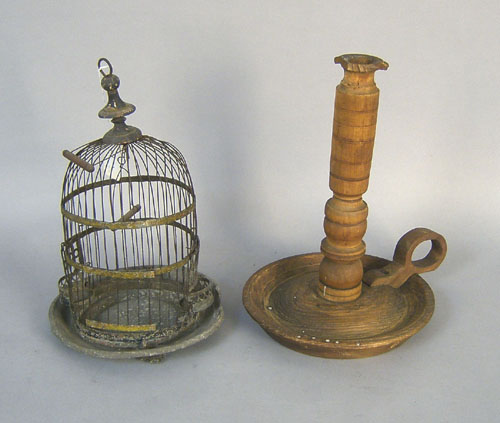 Appraisal: Tin birdcage h together with a wooden chamberstick Provenance The