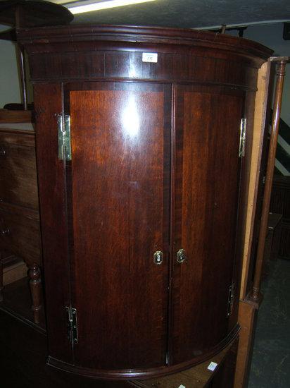 Appraisal: A Victorian bow fronted corner cupboard with brass locks and