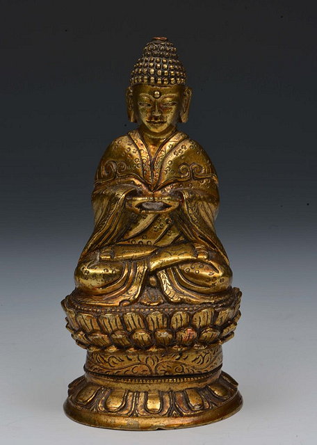 Appraisal: A TIBETAN GILT BRONZE FIGURE of a seated buddha with