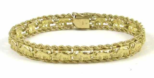 Appraisal: FOURTEEN KARAT GOLD ELEPHANT CARAVAN BRACELET featuring a full-length row