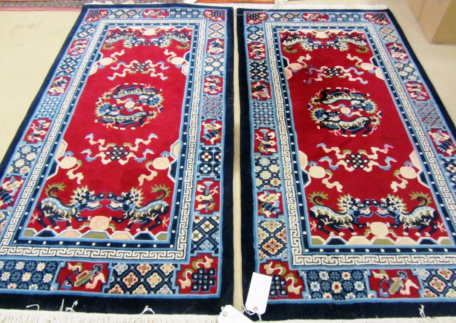 Appraisal: A pair of Chinese rugs the burgundy fields each with