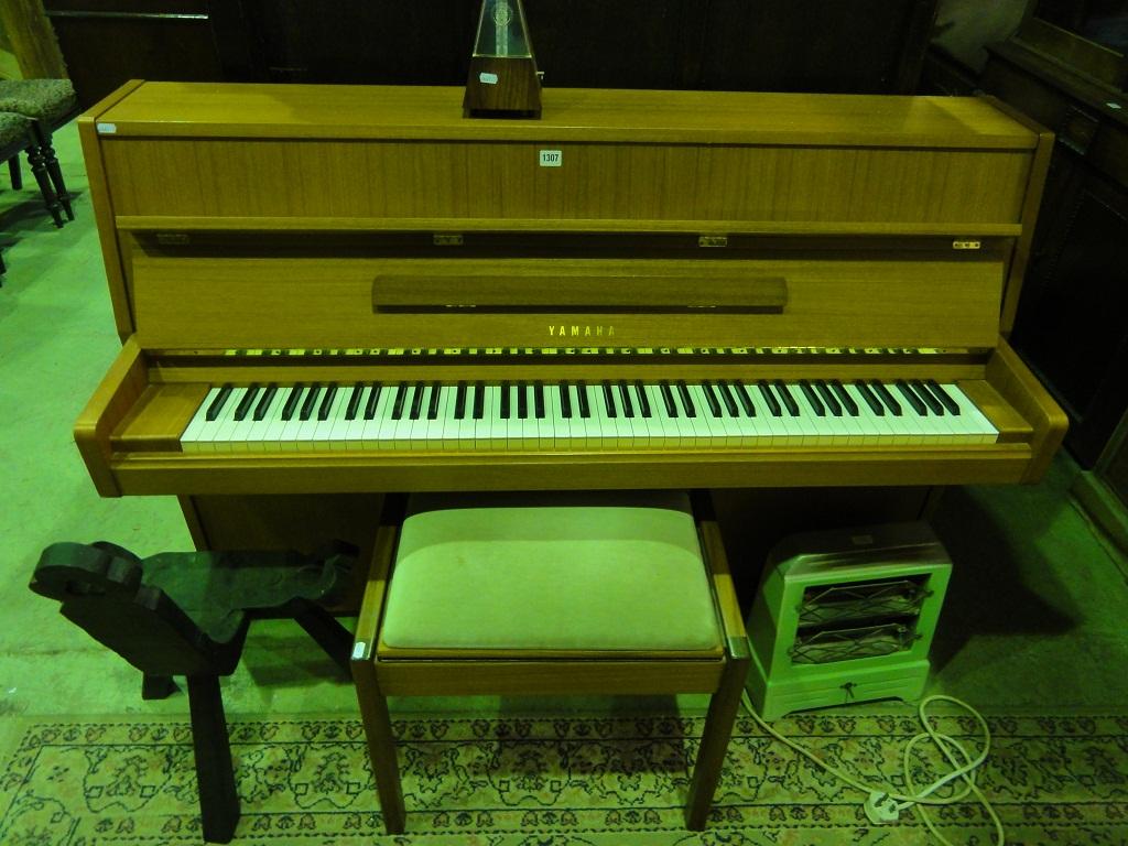 Appraisal: A modern Yamaha upright iron framed and overstrung piano within