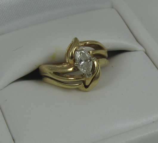 Appraisal: DIAMOND AND FOURTEEN KARAT GOLD SOLITAIRE RING centered and prong