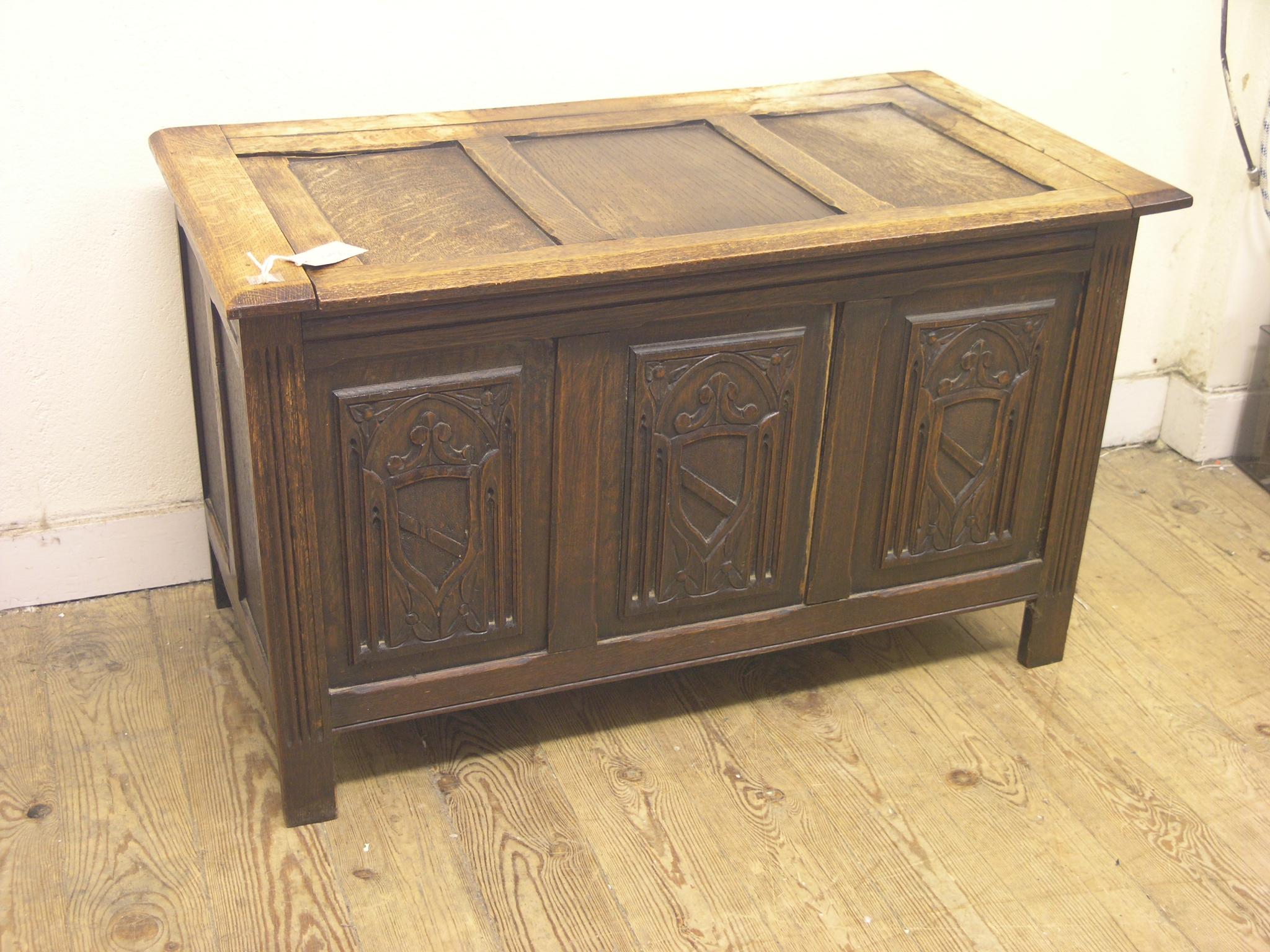 Appraisal: A dark oak coffer panelled construction with carved frontage ft