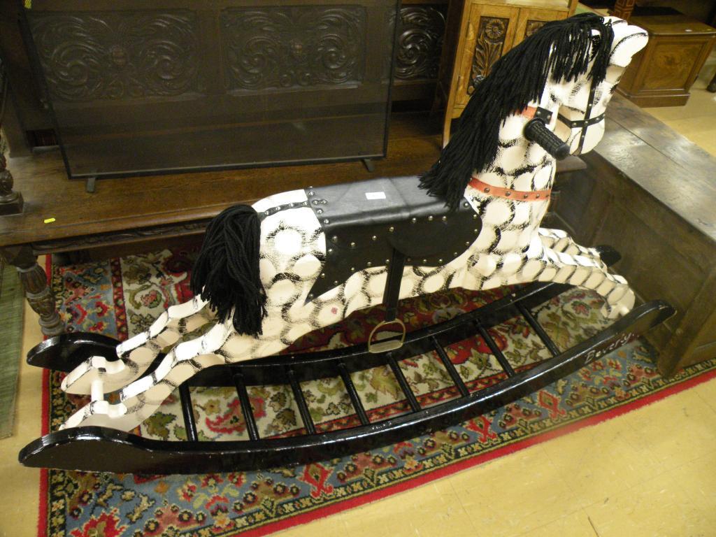 Appraisal: A hand made and painted rocking horse with shaped runners