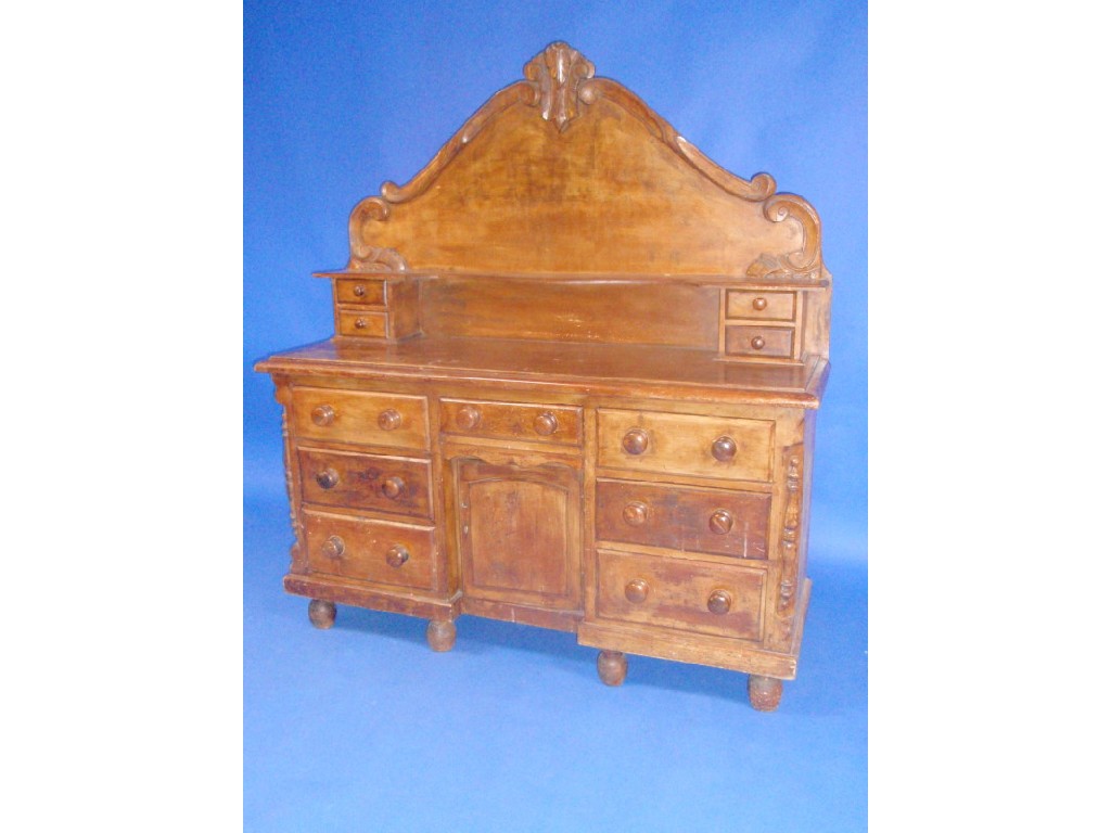 Appraisal: A Victorian pine dresser with shaped back drawers with knob