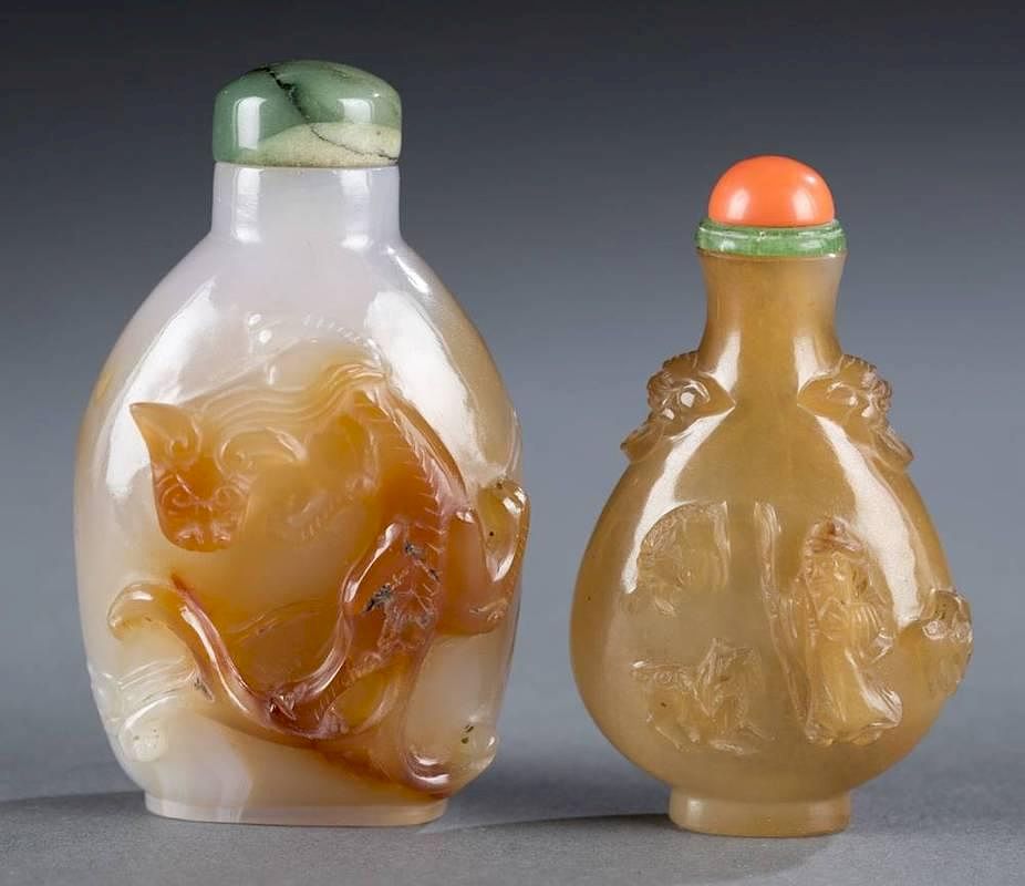 Appraisal: Pair of carved Chinese snuff bottles A pair of Chinese