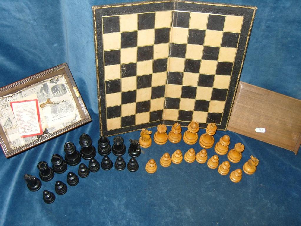 Appraisal: A mahogany case containing a set of turned wooden chessmen