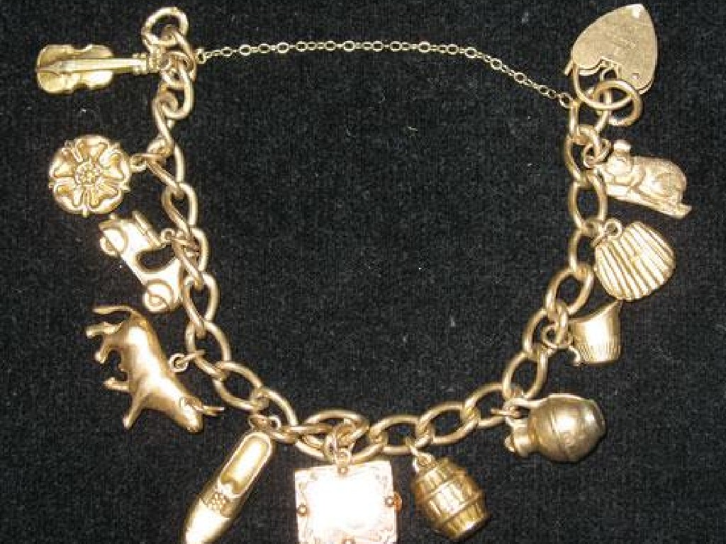 Appraisal: A CT YELLOW GOLD CURB LINK CHARM BRACELET with eleven