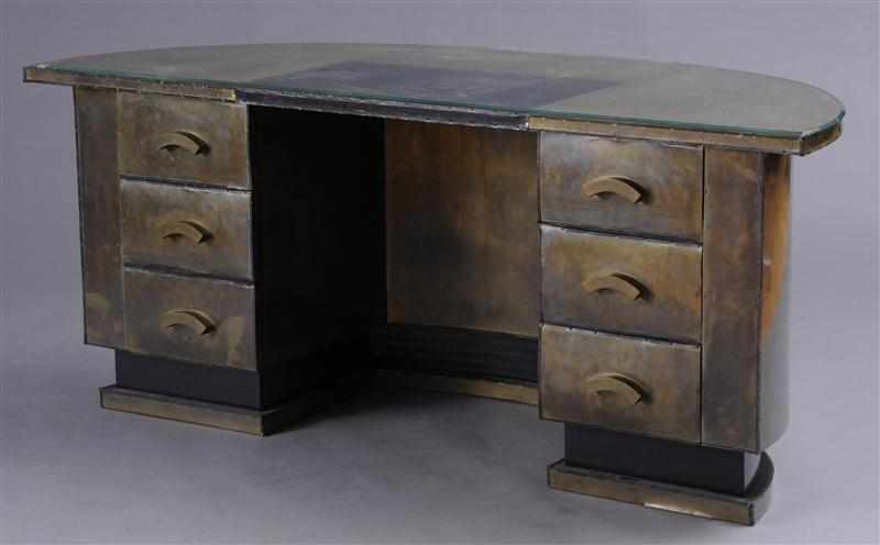 Appraisal: INDUSTRIAL SHEET BRASS-COVERED AND IRON-TRIMMED DESK The demilune glass-lined leather-inset