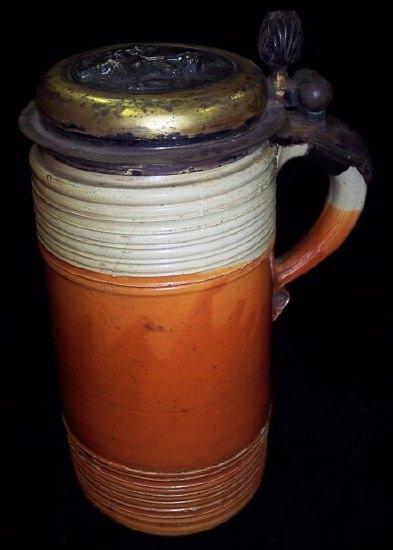 Appraisal: An th Century stoneglaze tankard with gilt metal cover decorated