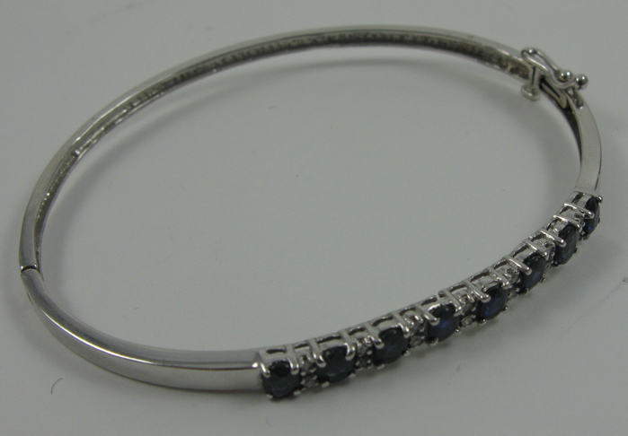 Appraisal: SAPPHIRE DIAMOND AND FOURTEEN KARAT GOLD BANGLE The white gold