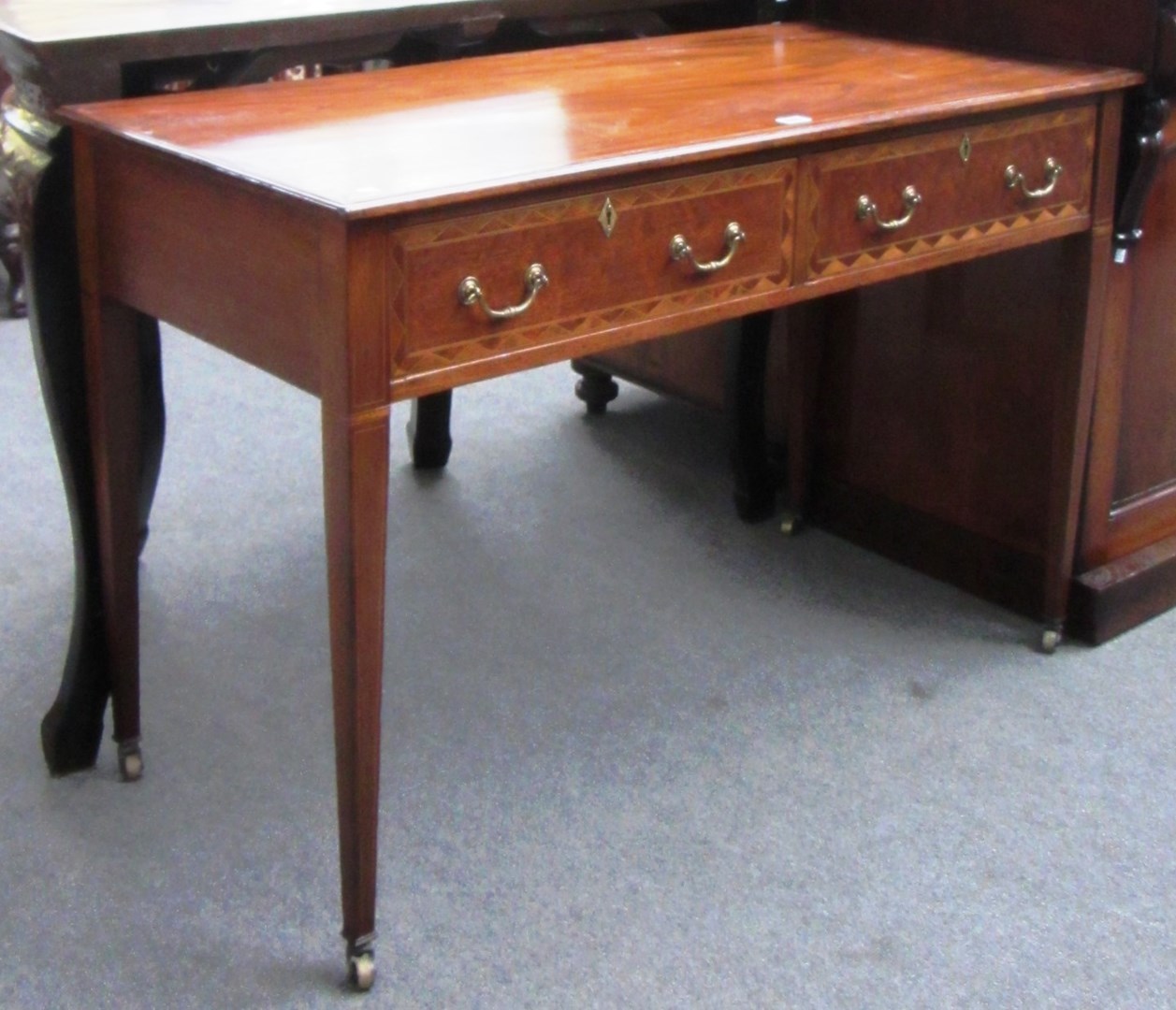 Appraisal: A late th century inlaid mahogany two drawer side table