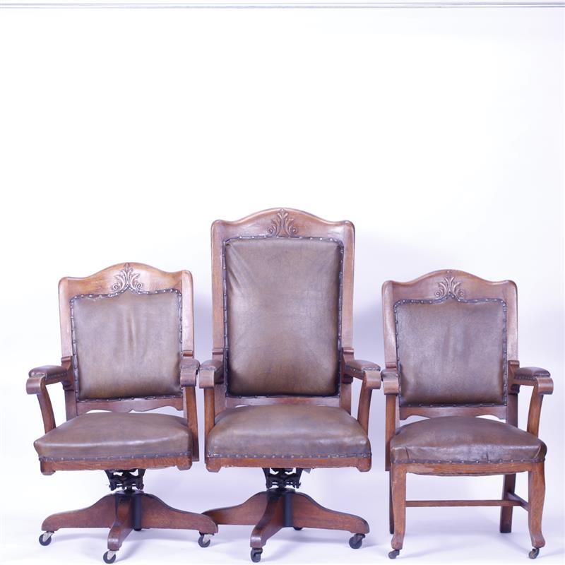 Appraisal: Three oak office chairs armchairs with carved detail and leather