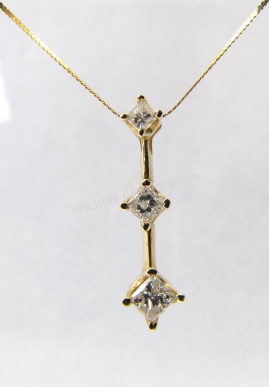 Appraisal: A K yellow gold chain with three princess cut diamond