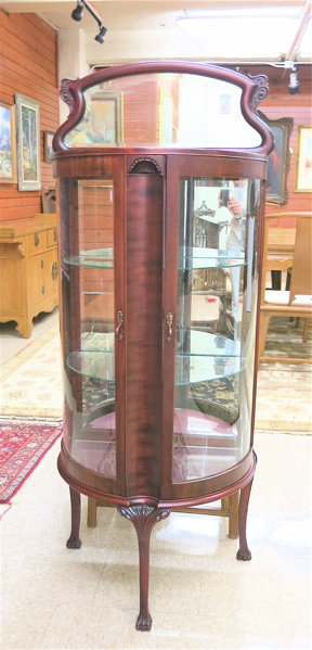 Appraisal: PETITE MAHOGANY AND CURVED GLASS CURIO CABINET American c the