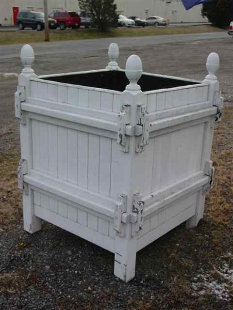 Appraisal: THREE LARGE WOOD PLANTERS With paneled sides and finials to