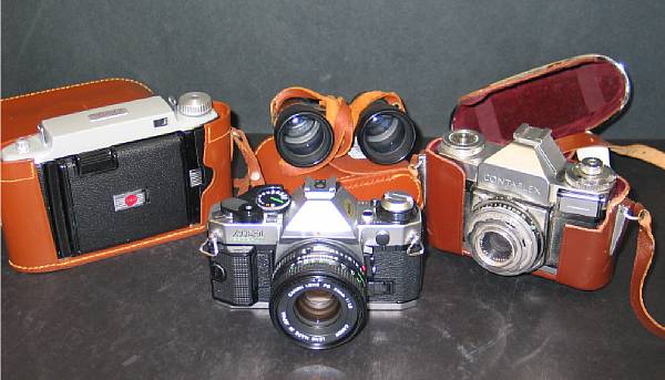 Appraisal: A group of three cameras and a pair of binoculars