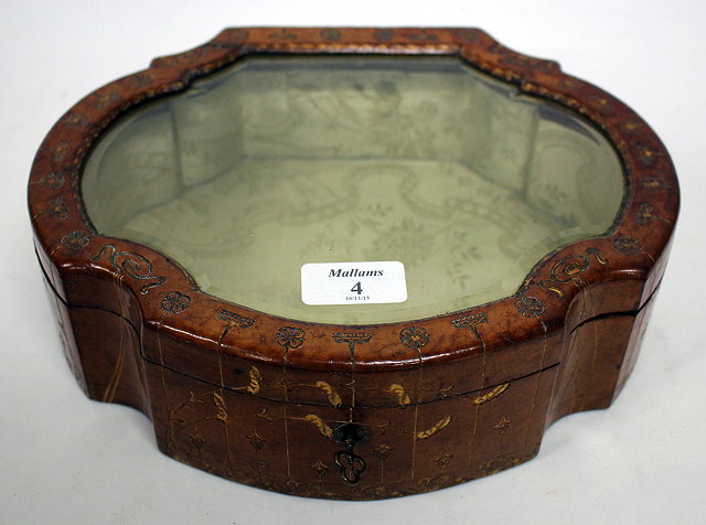 Appraisal: AN OLD LEATHER MOUNTED JEWELLERY BOX with serpentine outline the