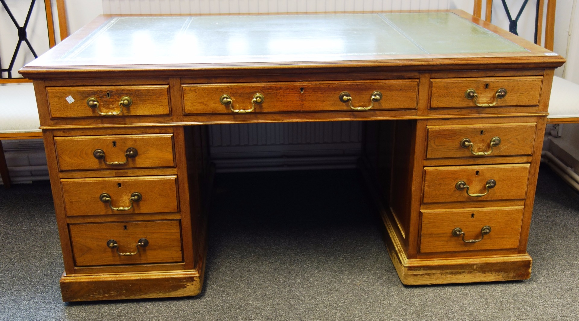 Appraisal: An th century style walnut pedestal desk with nine drawers