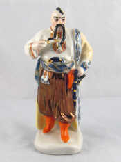 Appraisal: A Russian ceramic figure of a man in traditional dress