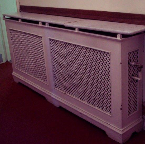 Appraisal: A double pierced cast radiator surround with pierced ends and