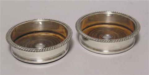 Appraisal: PAIR OF SHEFFIELD PLATED BOTTLE COASTERS With spiral gadrooned rims