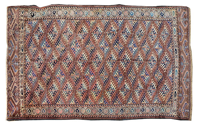 Appraisal: A TURKOMAN YOMUT BRICK RED GROUND MAIN CARPET with central