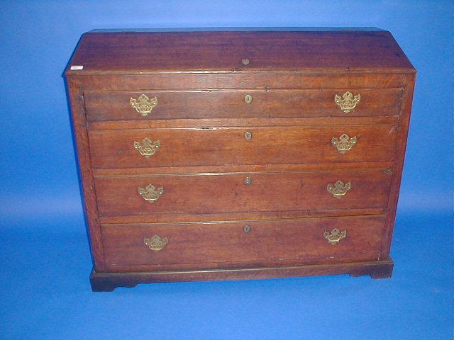 Appraisal: A Georgian oak chest with lift top over graduated drawers