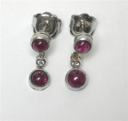 Appraisal: A pair of ruby and diamond pendant earrings each collet