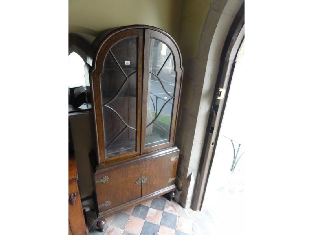 Appraisal: A small 's oak bookcase cupboard the upper section with