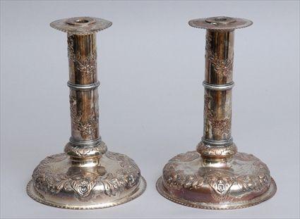 Appraisal: PAIR OF BAROQUE-STYLE SILVER-PLATED CANDLESTICKS Each circular stem with flower