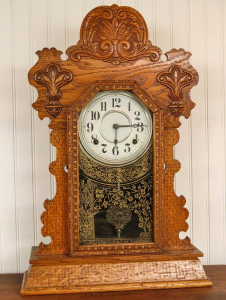 Appraisal: A CIRCA INGRAHAM OAK GINGERBREAD KITCHEN CLOCKTime and strike movement