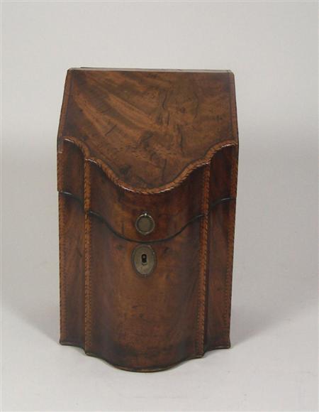 Appraisal: A George III mahogany and crossbanded serpentine fronted cutlery box